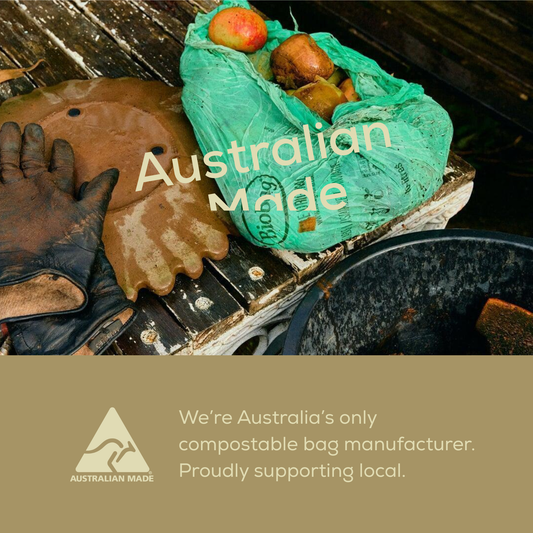 Green compostable bag with apples, gloves, and 'Australian Made' text on a brown background with Australian Made logo.