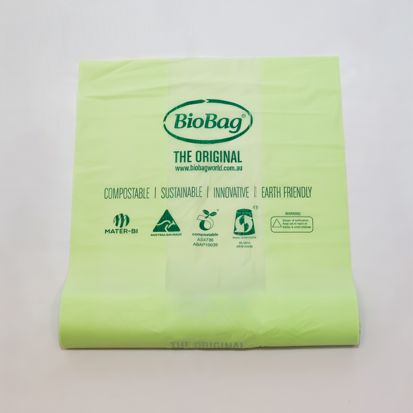 Roll of green 10L compostable bag with BioBag branding on a light gray background