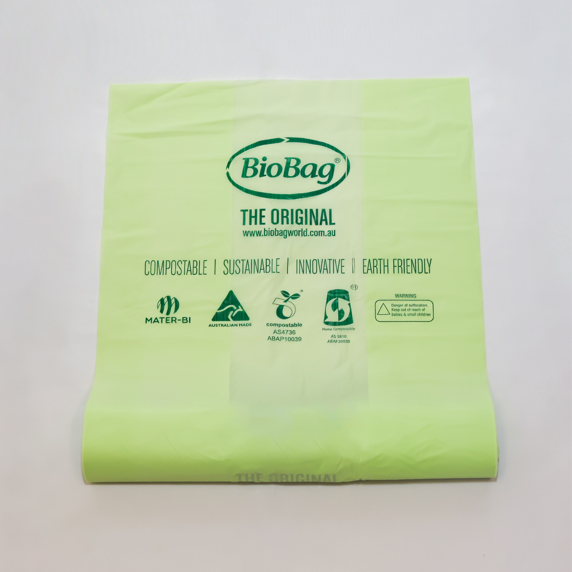 Roll of green 10L compostable bag with BioBag branding on a light gray background