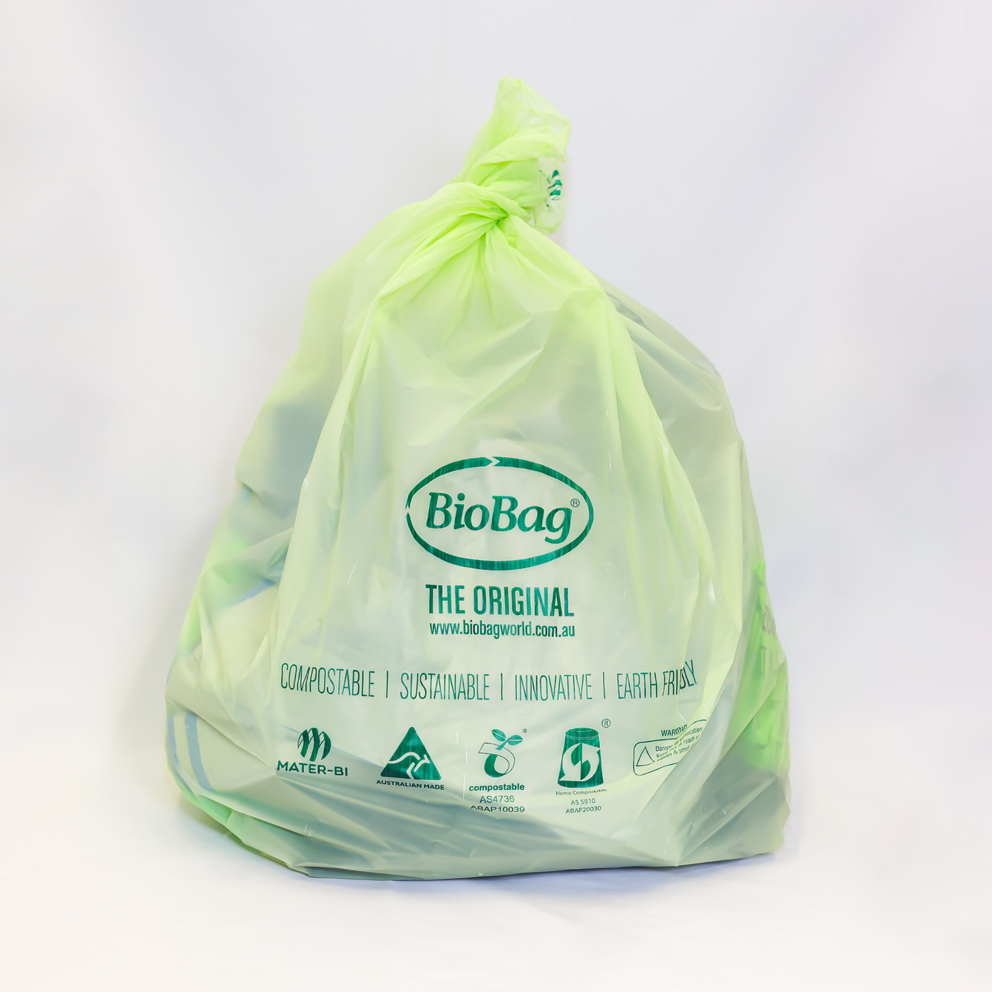 Green 10L compostable bag in use with BioBag branding on a white background
