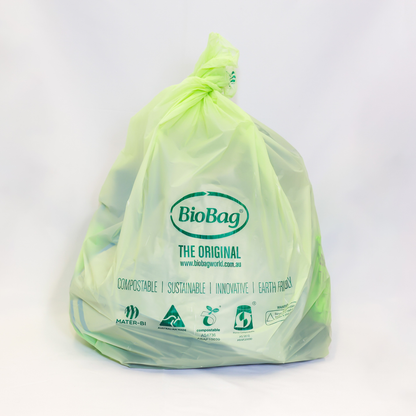 Green 10L compostable bag in use with BioBag branding on a white background