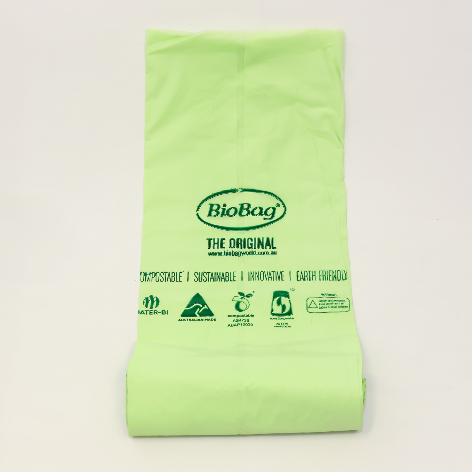 Image of a roll of BioBag 80L compostable bin liners showing the Australian made logo, and the compostable certification logos. 