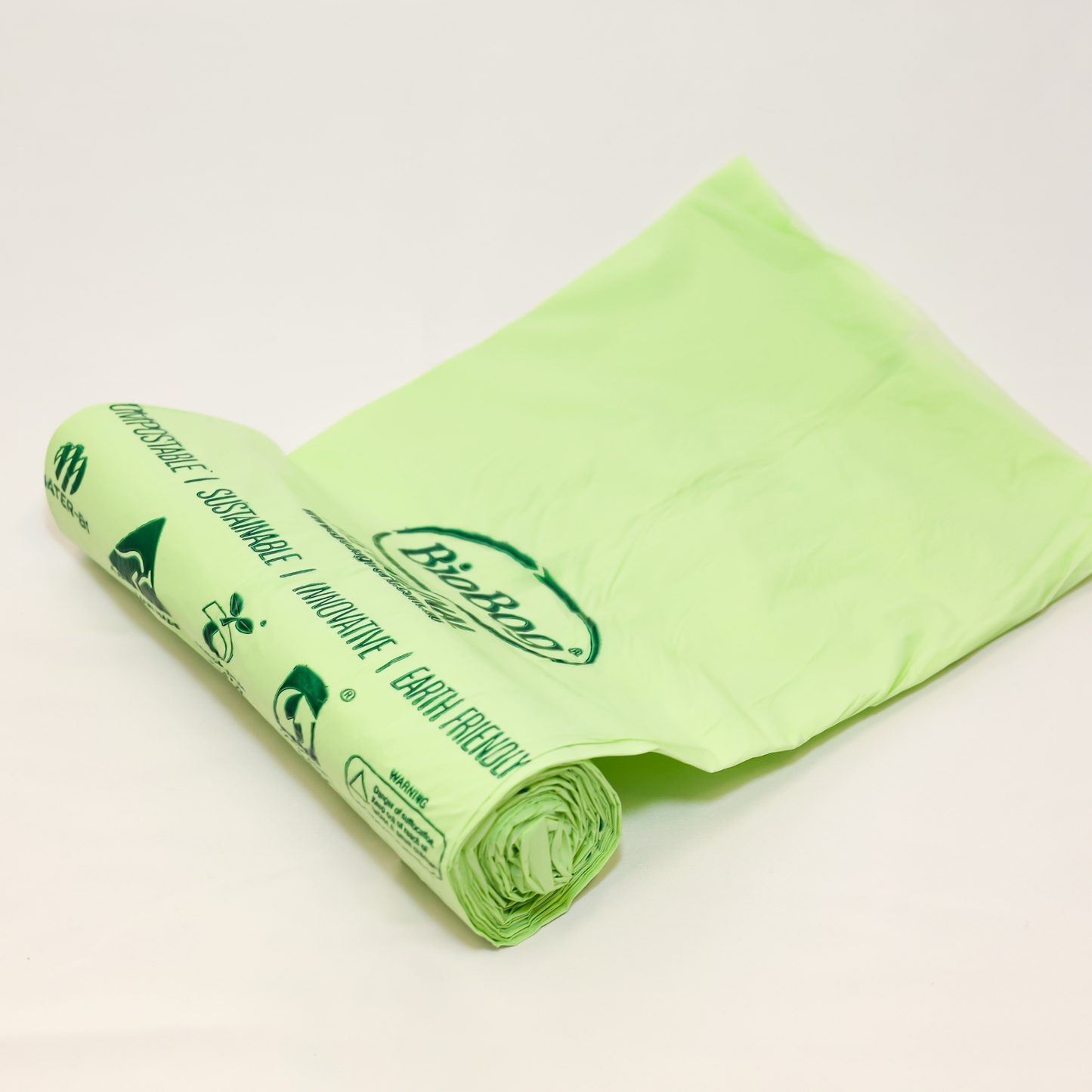 Image of a roll of the 80L BioBag compostable bin liners, showing the words compostable, sustainable, innovative, and earth friendly. 