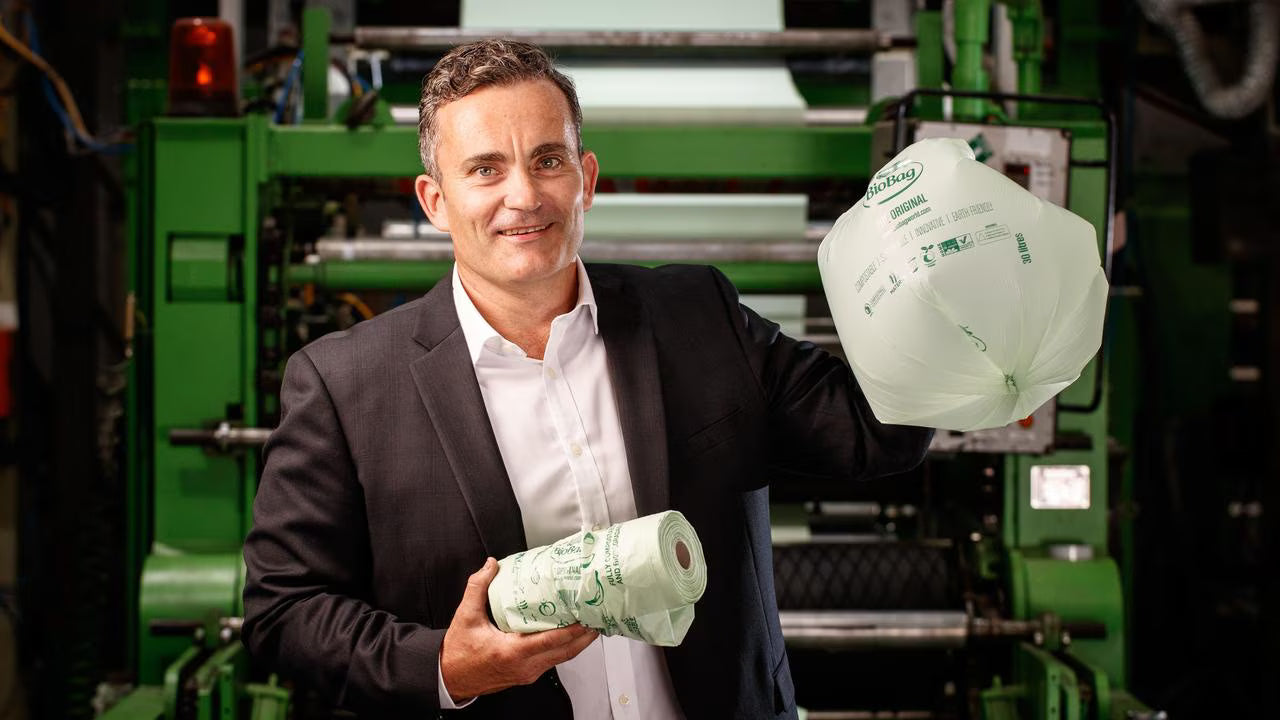 Photo of Managing Director Scott Morton  BioBag manufacturing facility in Adelaide, holding a the locally made product