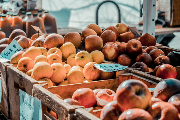 Photo of a farmers market apple stall - showing what can go in a compostable bin bag. 